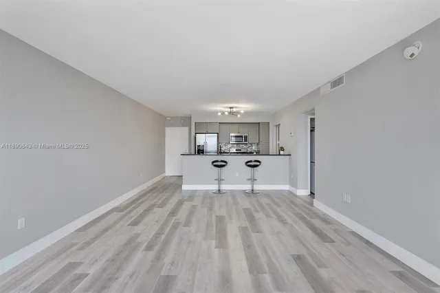 a view of kitchen with furniture and wooden floor