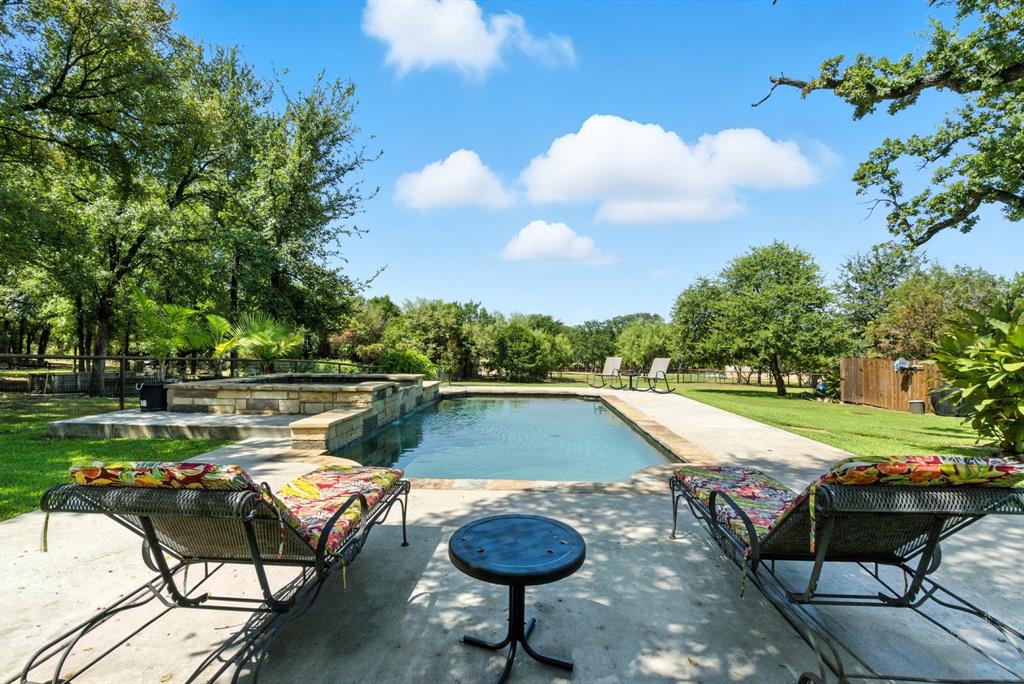 a view of a swimming pool and lounge chairs