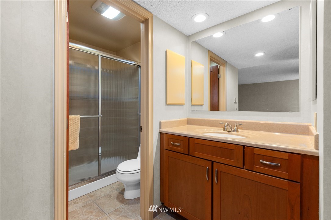 22230 5th Place West Bothell, WA 98021 - Photo 11 of 34 a bathroom with a toilet a sink and a large mirror