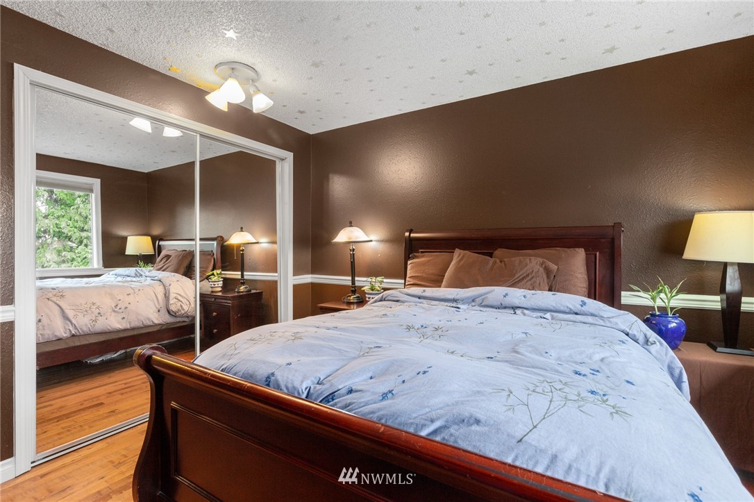 22230 5th Place West Bothell, WA 98021 - Photo 14 of 34 a bedroom with a bed and wooden floor