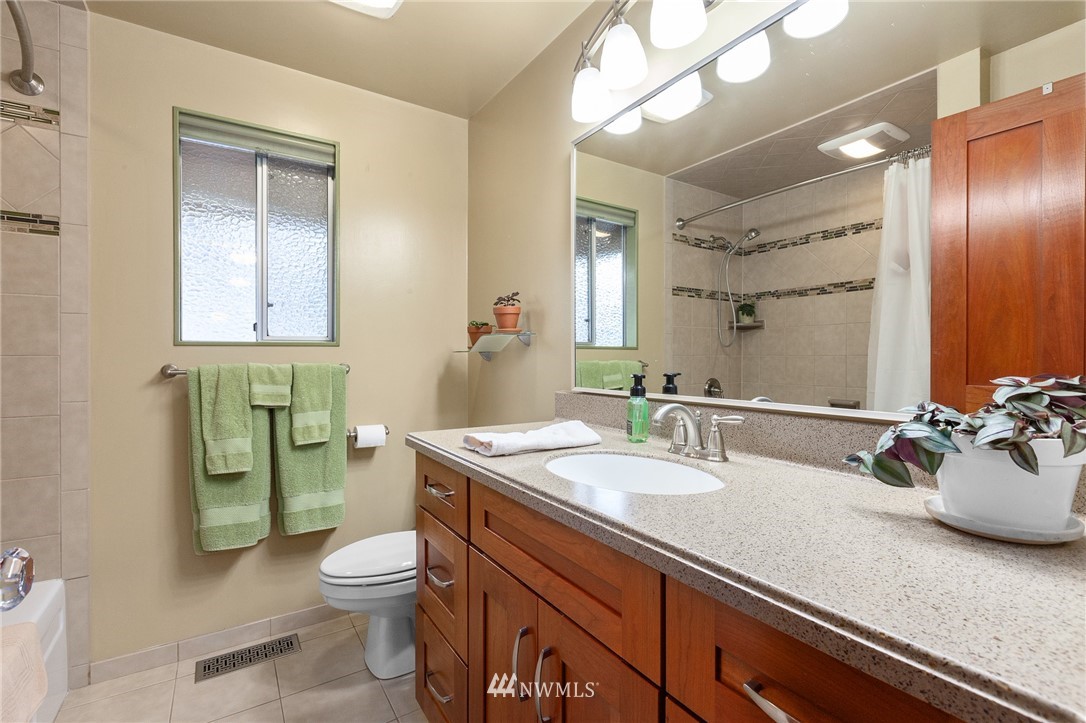 22230 5th Place West Bothell, WA 98021 - Photo 16 of 34 a bathroom with a granite countertop sink mirror and toilet