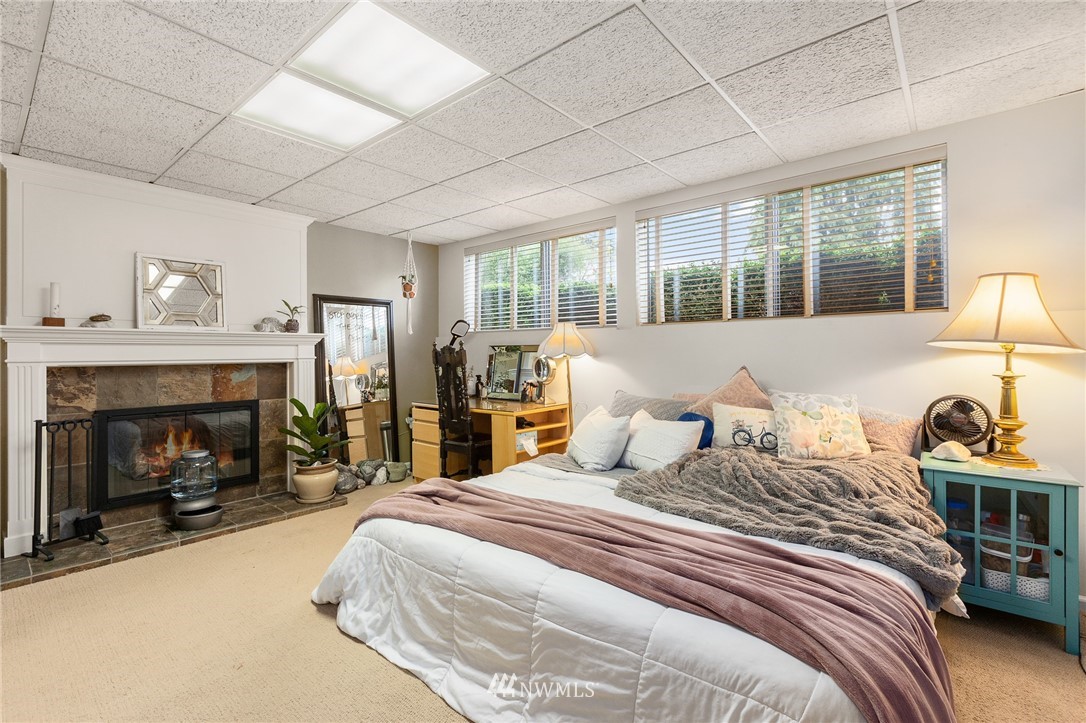 22230 5th Place West Bothell, WA 98021 - Photo 23 of 34 a bedroom with a bed and a fireplace