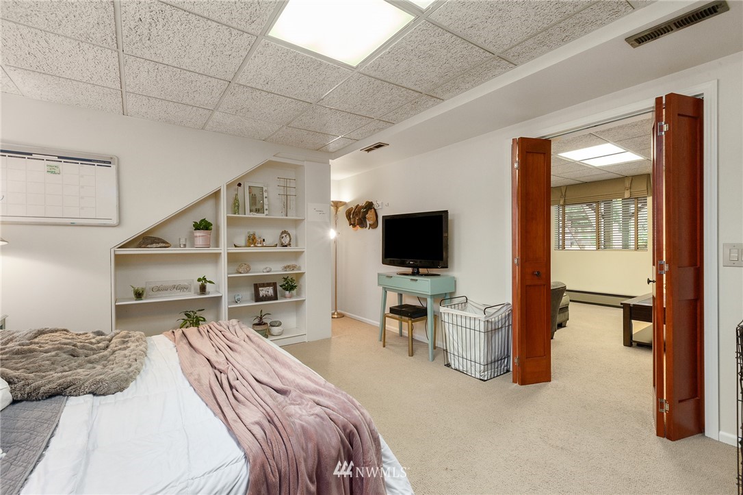 22230 5th Place West Bothell, WA 98021 - Photo 24 of 34 a bedroom with a bed and a flat screen tv