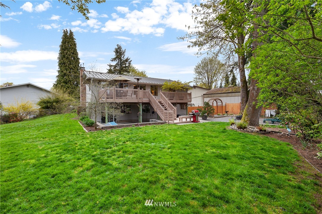 22230 5th Place West Bothell, WA 98021 - Photo 30 of 34 a view of a house with a big yard potted plants and a large tree
