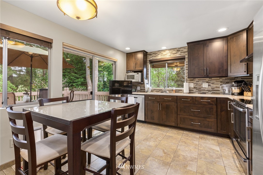22230 5th Place West Bothell, WA 98021 - Photo 6 of 34 a kitchen with stainless steel appliances granite countertop a stove a sink and a refrigerator