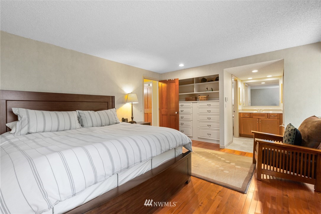 22230 5th Place West Bothell, WA 98021 - Photo 8 of 34 a spacious bedroom with a bed and wooden floor