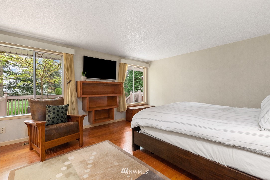 22230 5th Place West Bothell, WA 98021 - Photo 9 of 34 a bedroom with a bed a flat screen tv and a fireplace