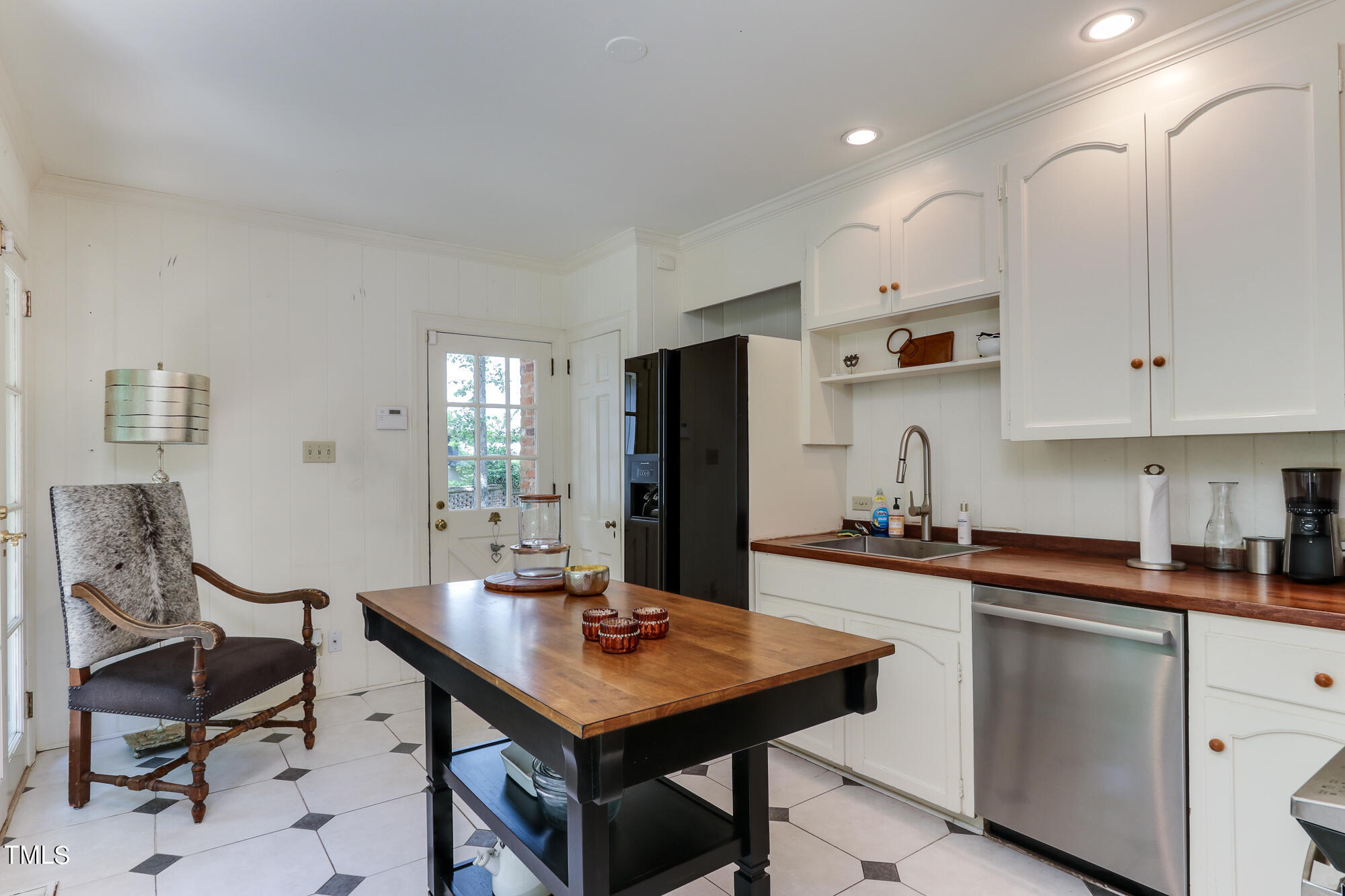 3231 Sussex Road Raleigh, NC 27607 - Photo 11 of 33 a kitchen with a table chairs and refrigerator