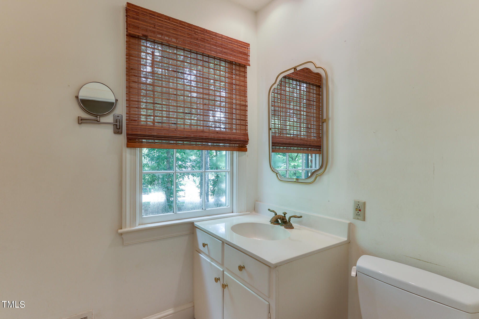 3231 Sussex Road Raleigh, NC 27607 - Photo 17 of 33 a bathroom with a sink a toilet and a window