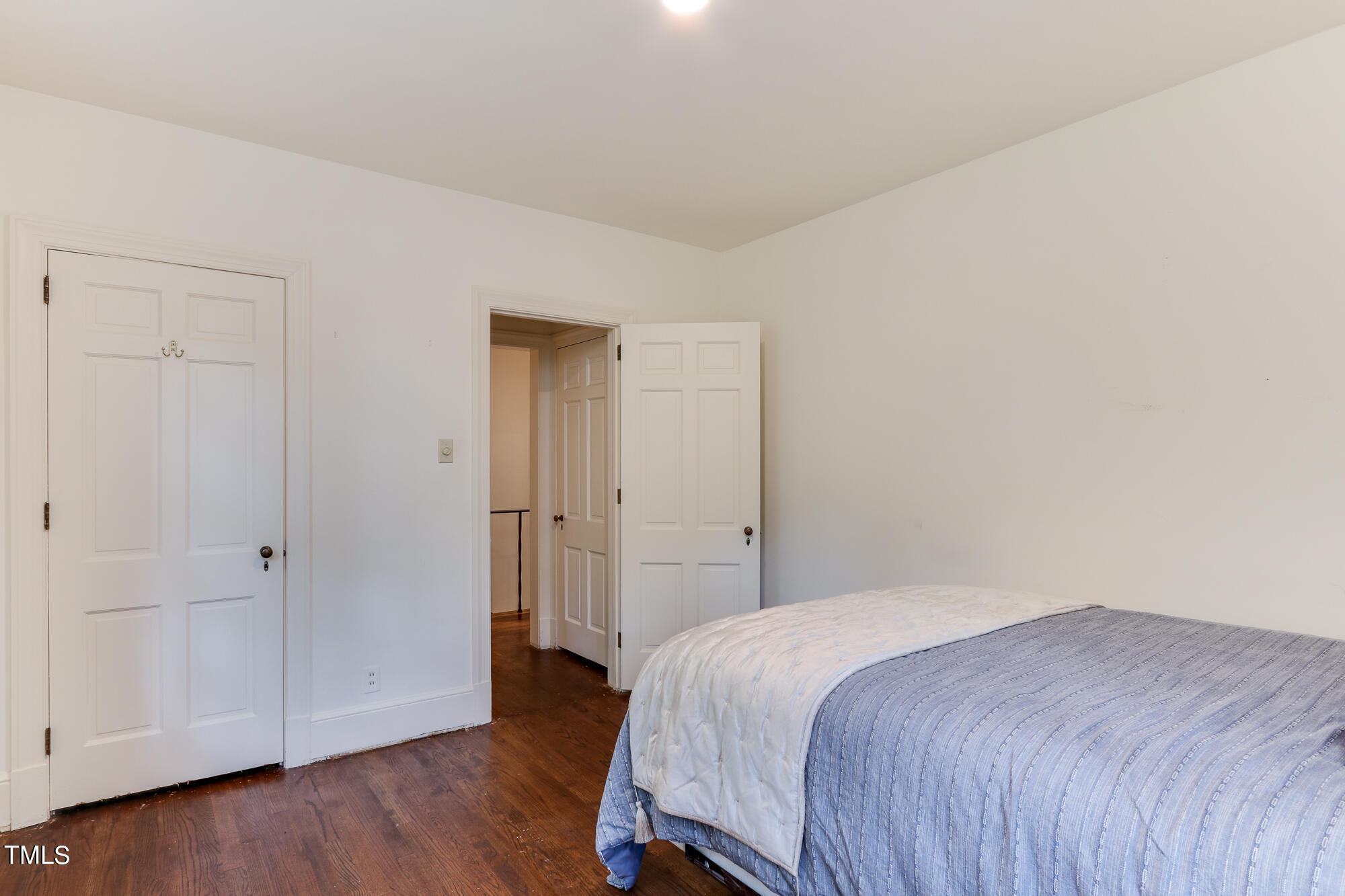 3231 Sussex Road Raleigh, NC 27607 - Photo 19 of 33 a bedroom with a bed and wooden floor