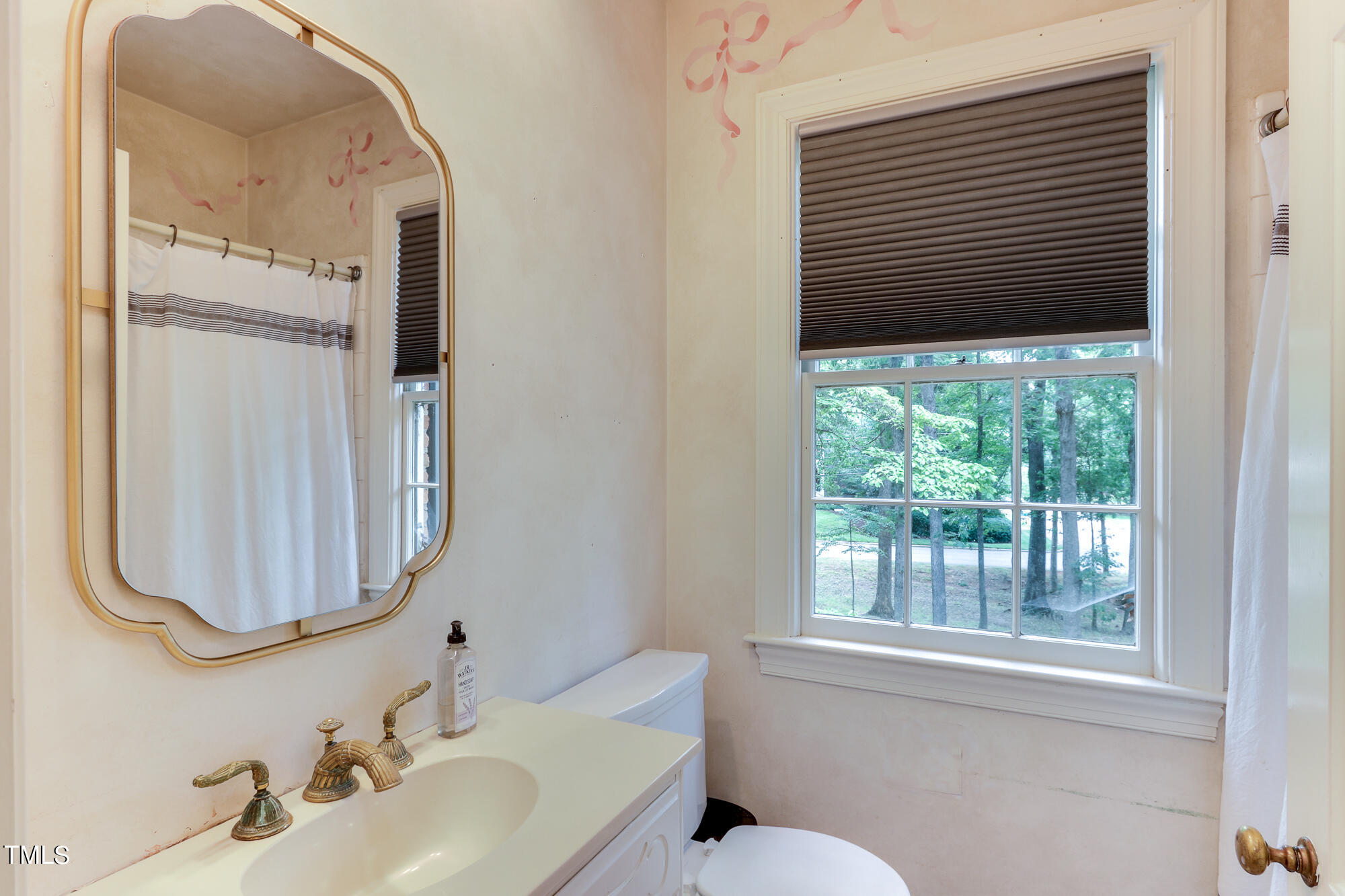 3231 Sussex Road Raleigh, NC 27607 - Photo 20 of 33 a bathroom with a sink and a mirror