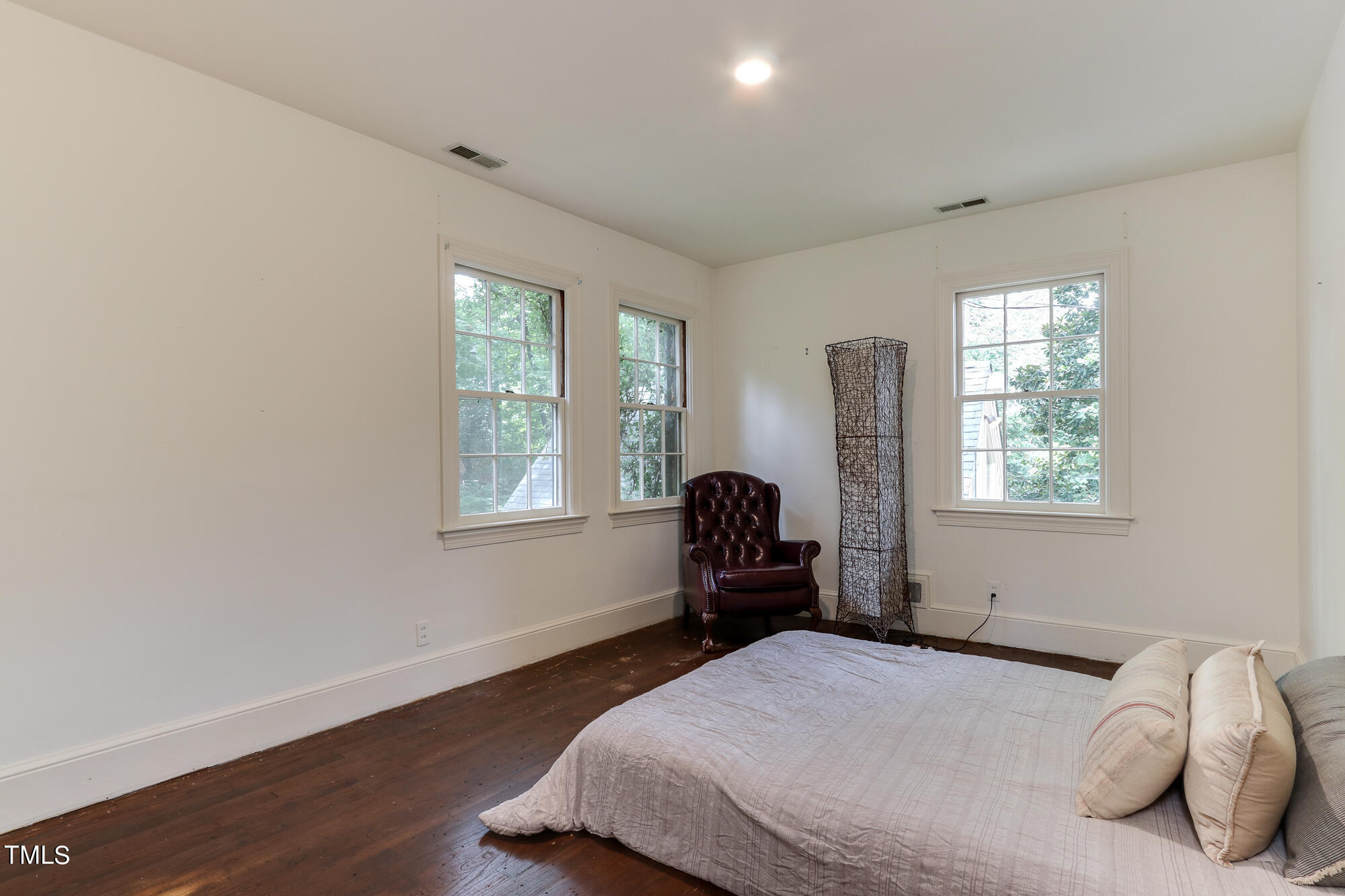 3231 Sussex Road Raleigh, NC 27607 - Photo 21 of 33 a bedroom with a bed and wooden floor