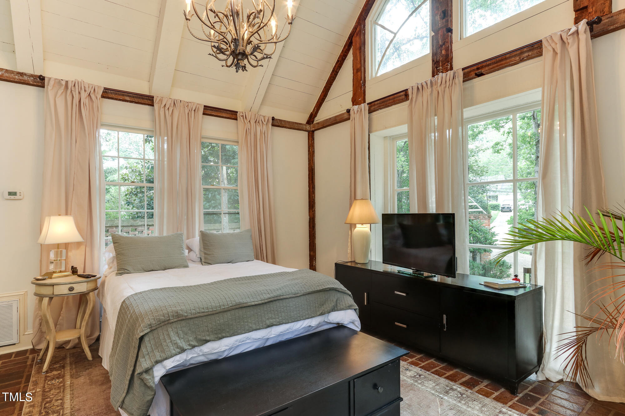 3231 Sussex Road Raleigh, NC 27607 - Photo 22 of 33 a bedroom with a bed and a flat screen tv