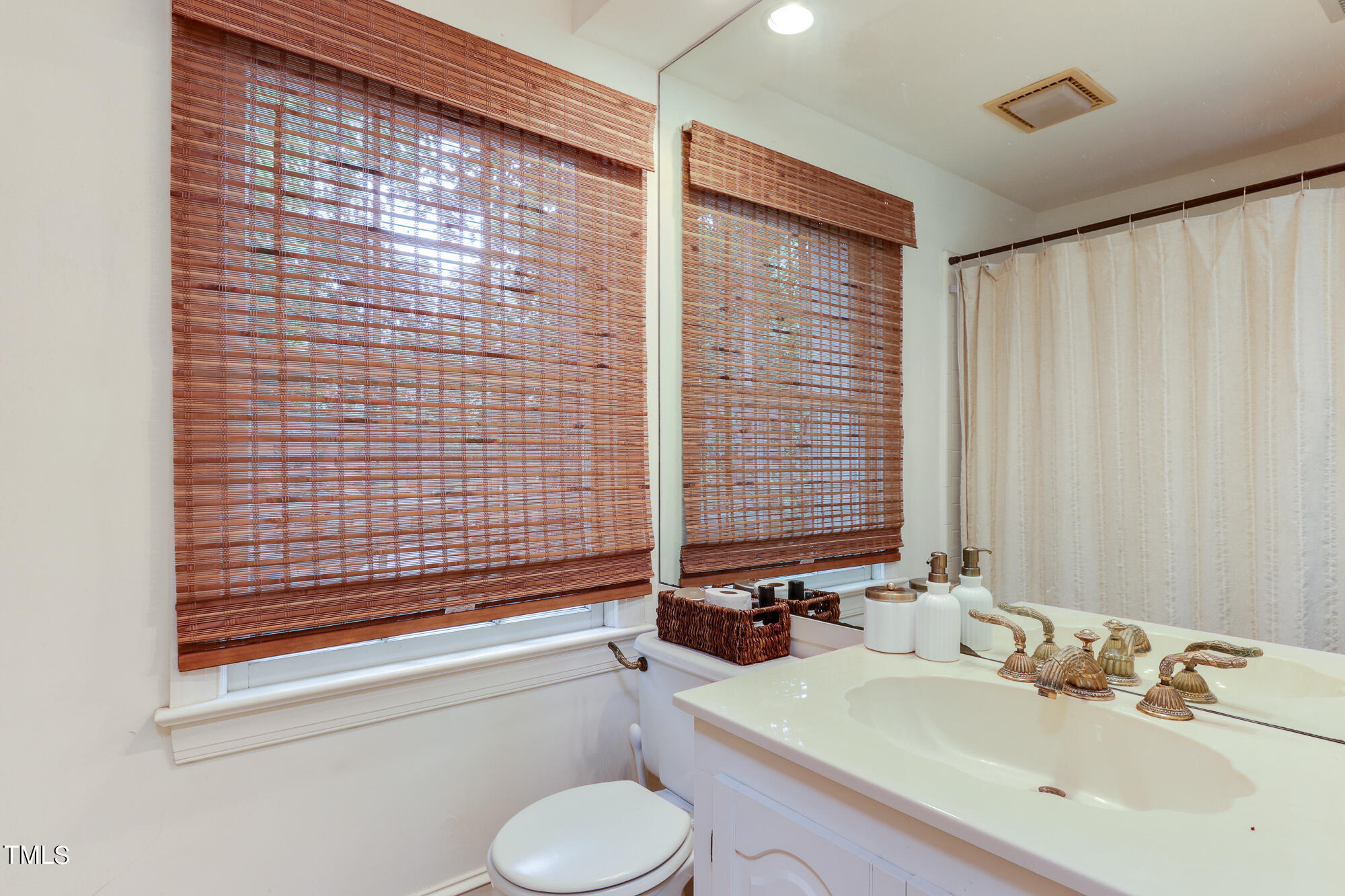 3231 Sussex Road Raleigh, NC 27607 - Photo 25 of 33 a bathroom with a sink and a mirror