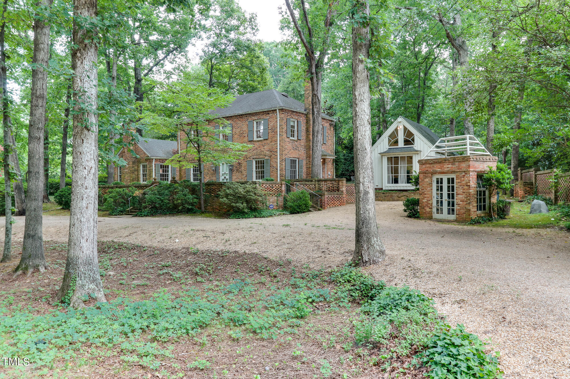 3231 Sussex Road Raleigh, NC 27607 - Photo 3 of 33 a front view of a house with a yard and large trees