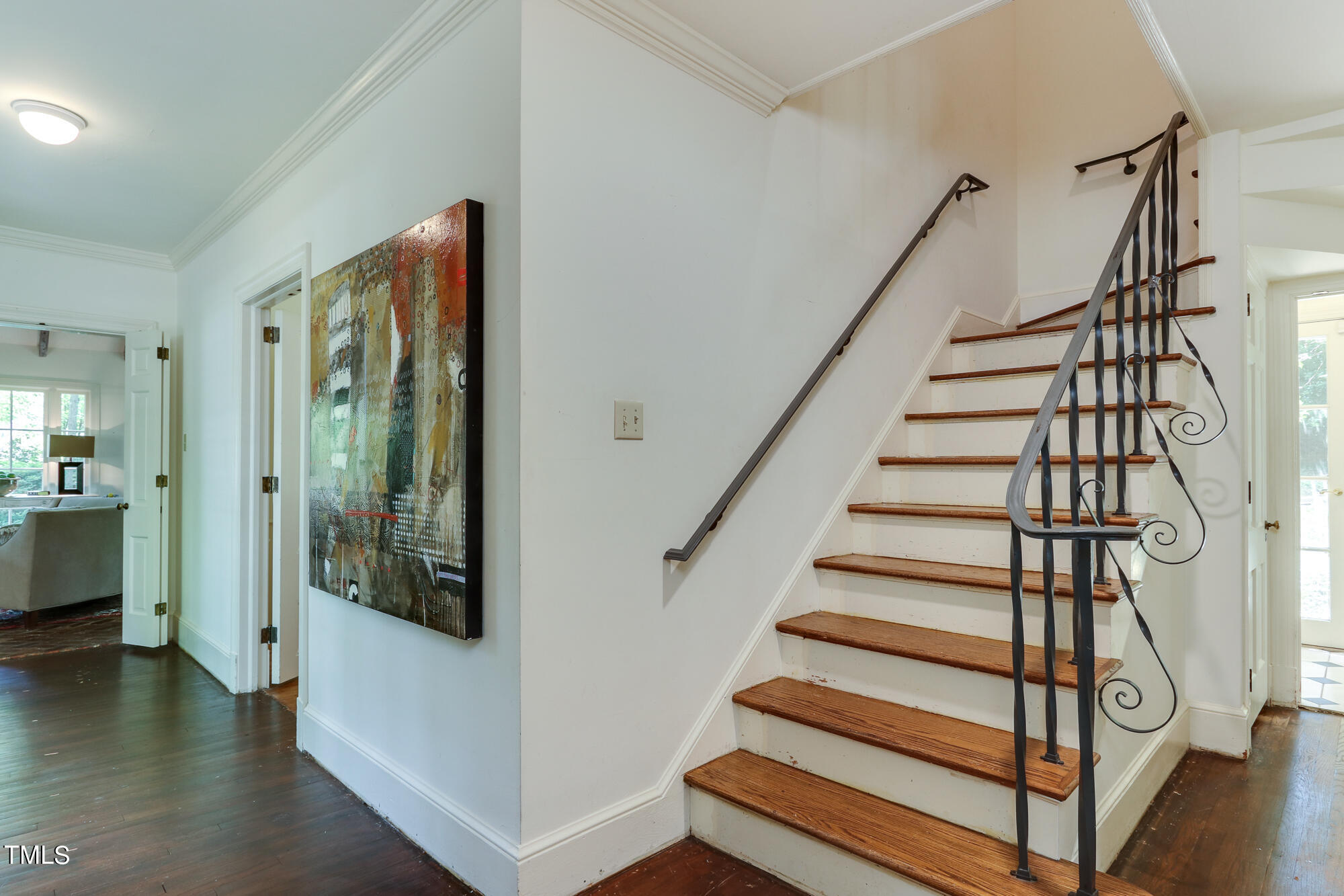 3231 Sussex Road Raleigh, NC 27607 - Photo 5 of 33 a view of entryway with wooden floor and stairs