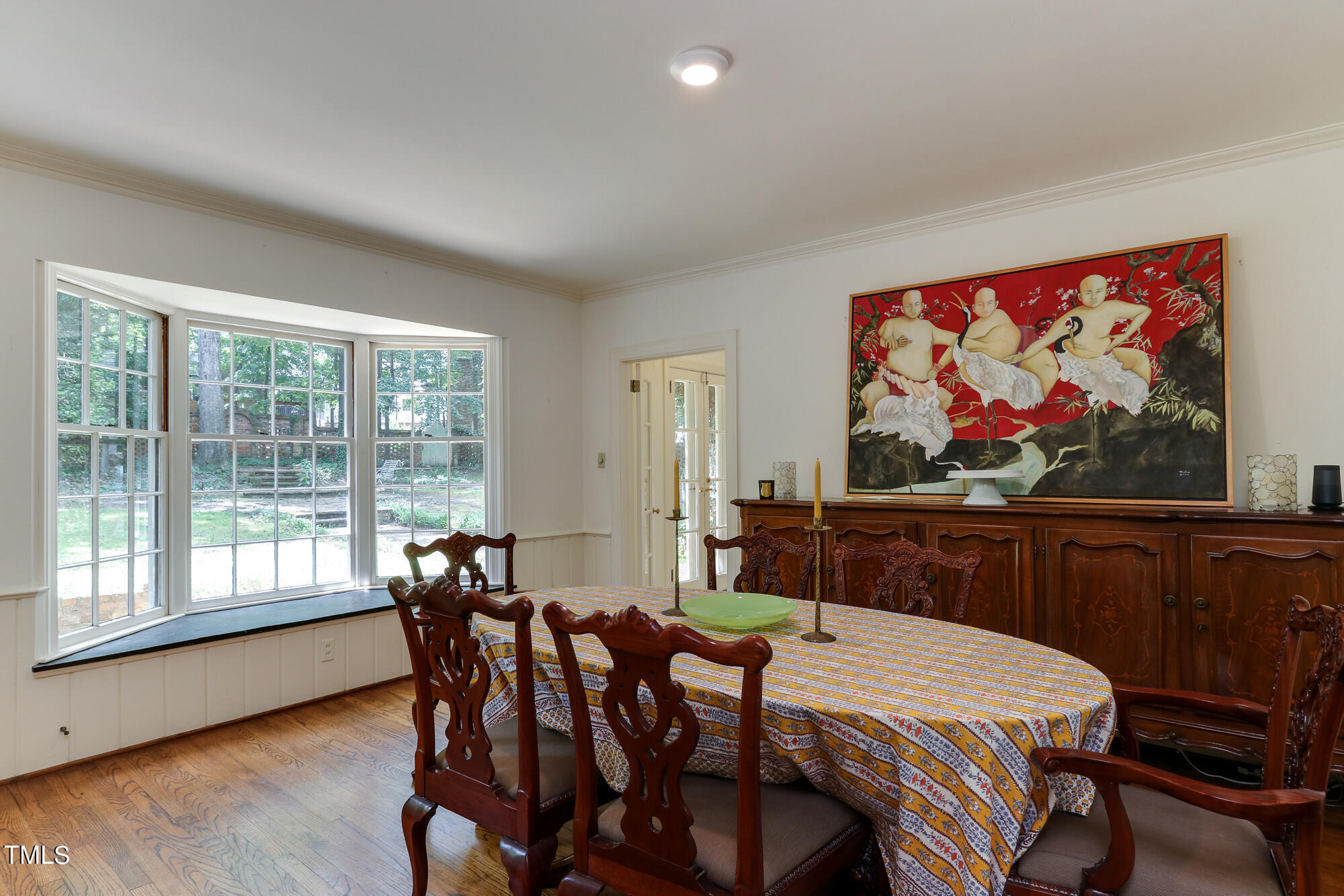 3231 Sussex Road Raleigh, NC 27607 - Photo 9 of 33 a view of a dining room with furniture a chandelier and wooden floor