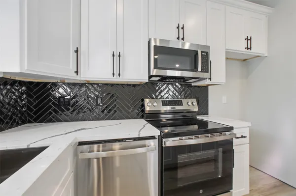 a kitchen with a stove and a microwave