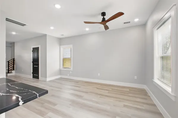 a view of a livingroom with a ceiling fan and window