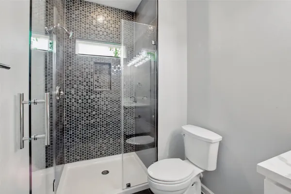 a white toilet sitting next to a bathroom sink