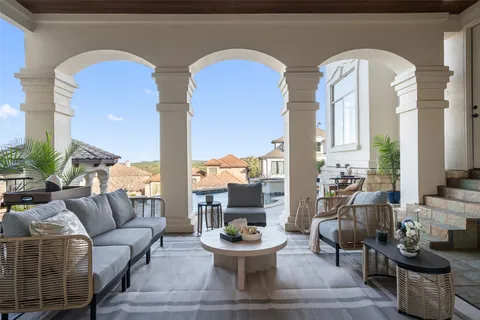 a living room with couches and a potted plant