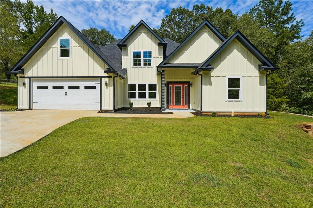 a front view of house with yard and green space