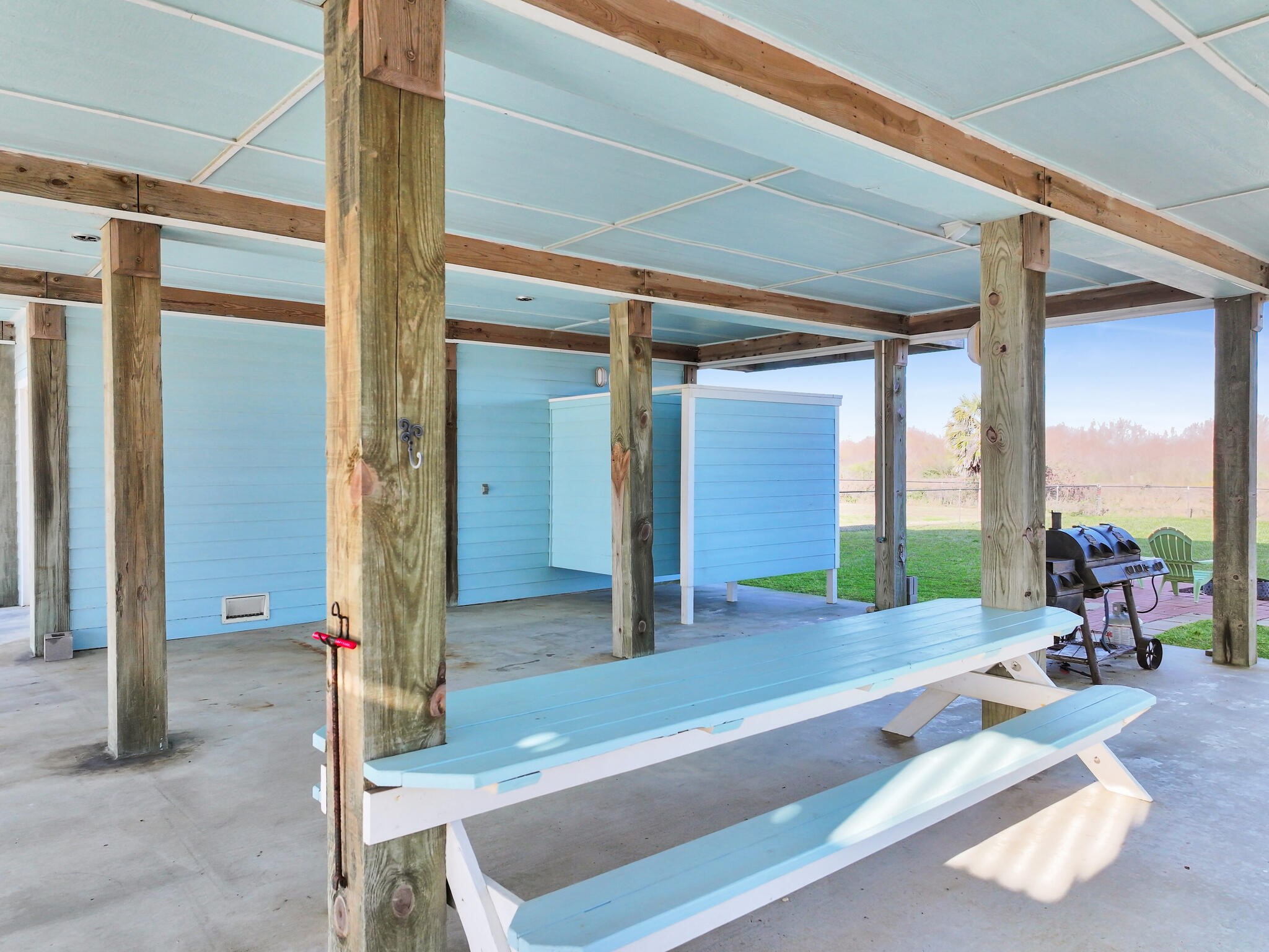 353 Atkinson Street Crystal Beach, TX 77650 - Photo 11 of 42 a swimming pool with outdoor seating and a garden