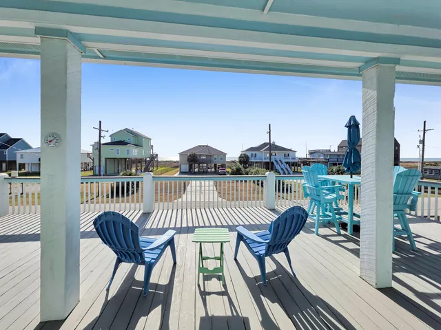 a balcony with wooden floor outdoor seating and city view