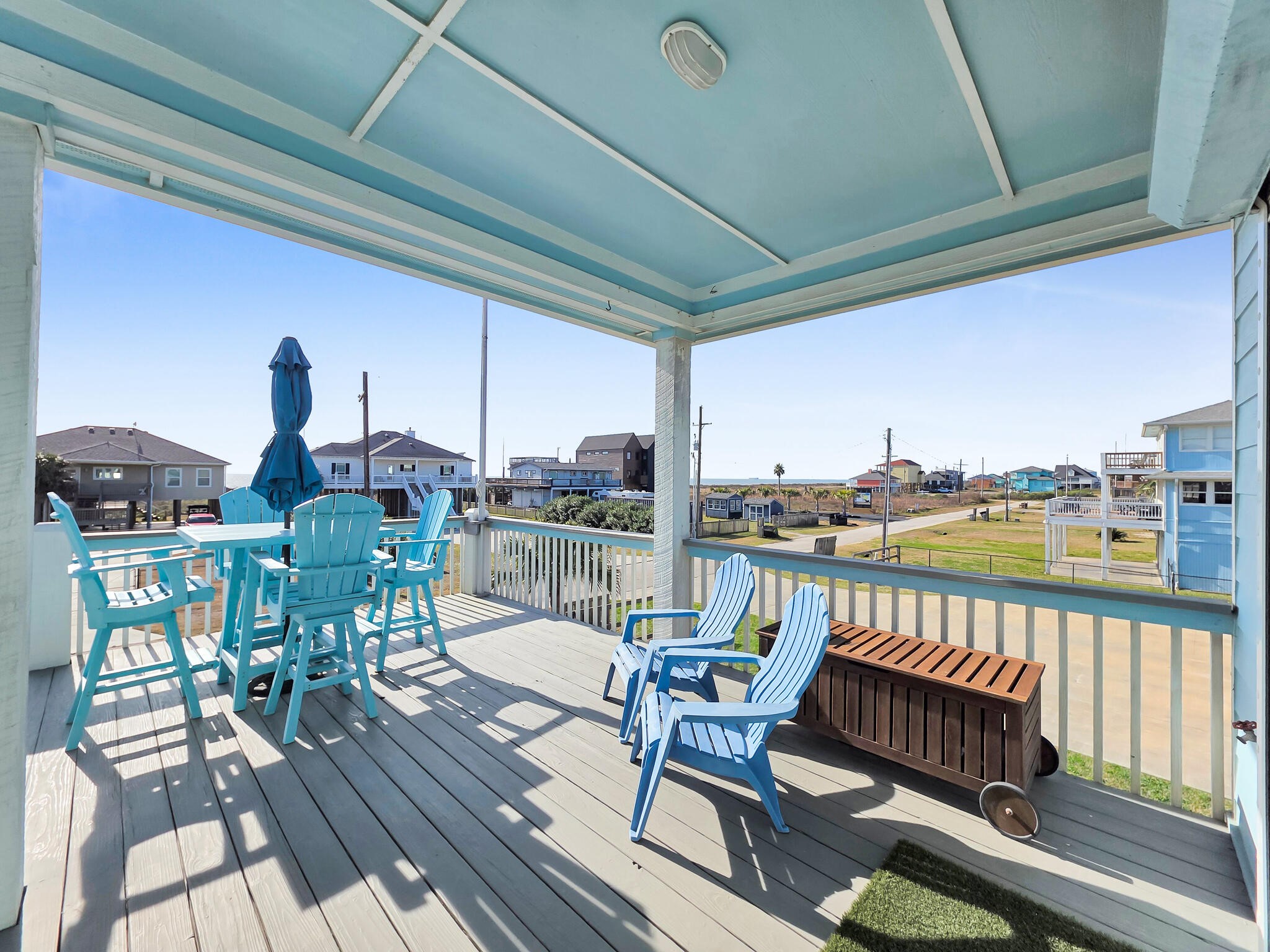 353 Atkinson Street Crystal Beach, TX 77650 - Photo 14 of 42 a balcony with wooden floor outdoor seating and city view