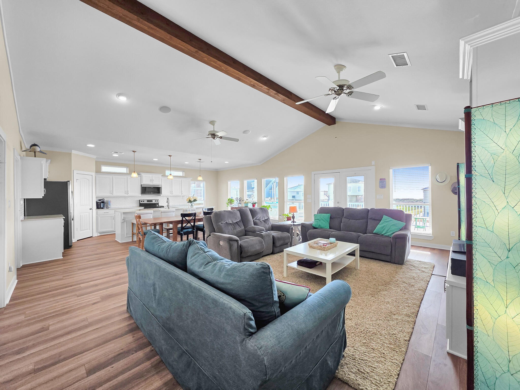 353 Atkinson Street Crystal Beach, TX 77650 - Photo 18 of 42 a living room with furniture kitchen view and a wooden floor