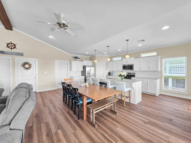a living room with furniture a flat screen tv and a table
