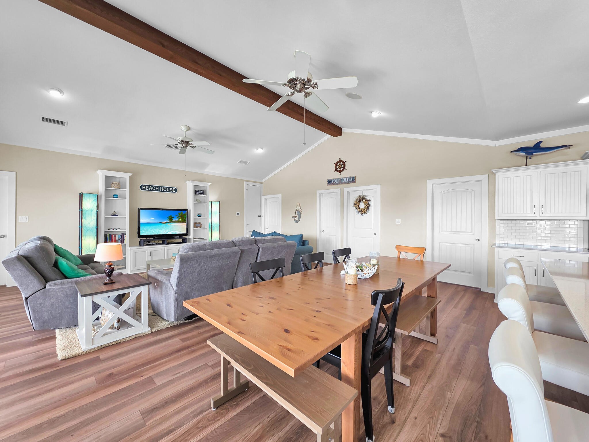 353 Atkinson Street Crystal Beach, TX 77650 - Photo 21 of 42 a living room with furniture a flat screen tv and a table