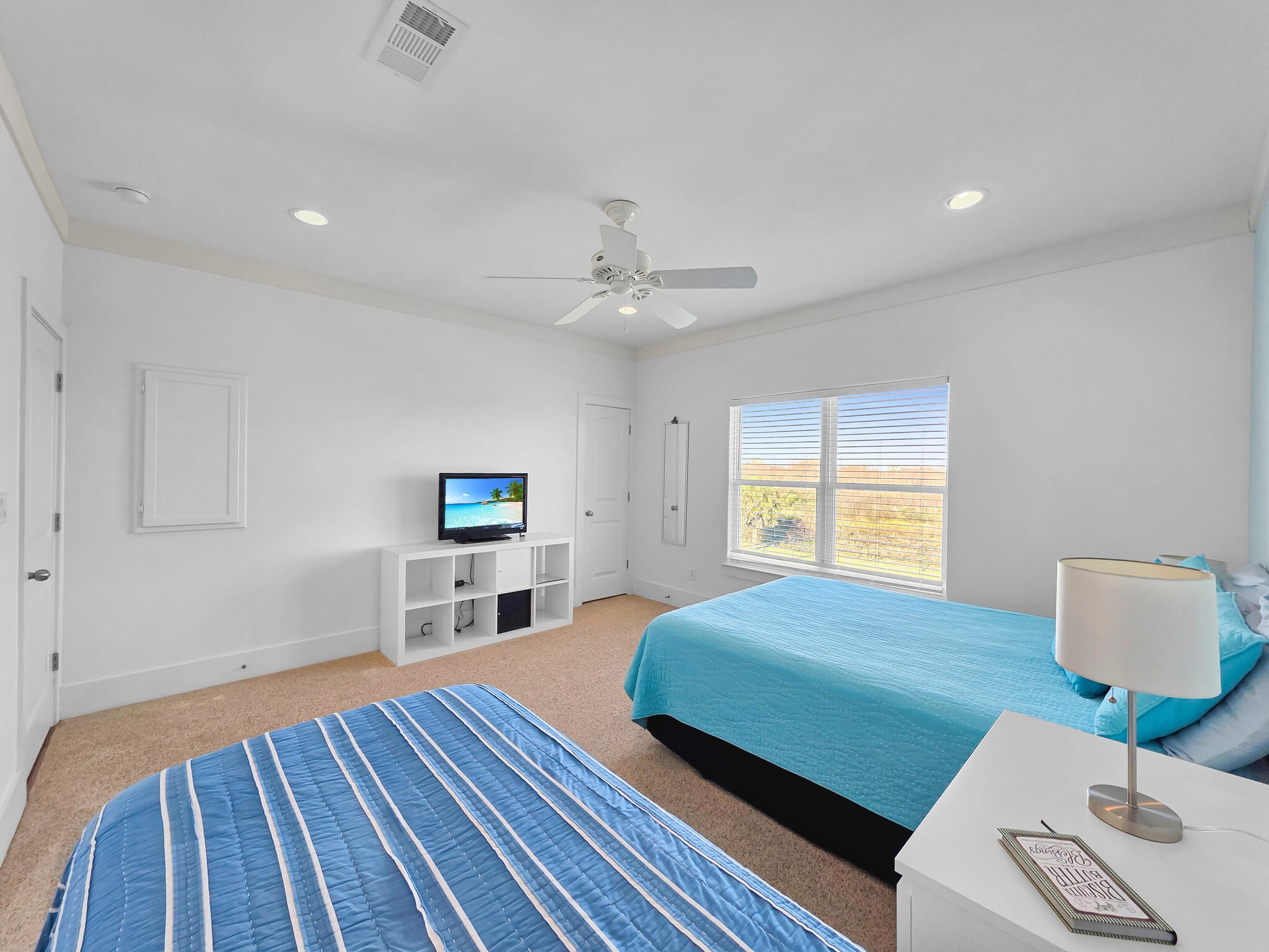 353 Atkinson Street Crystal Beach, TX 77650 - Photo 30 of 42 a bedroom with a bed and a wooden floor