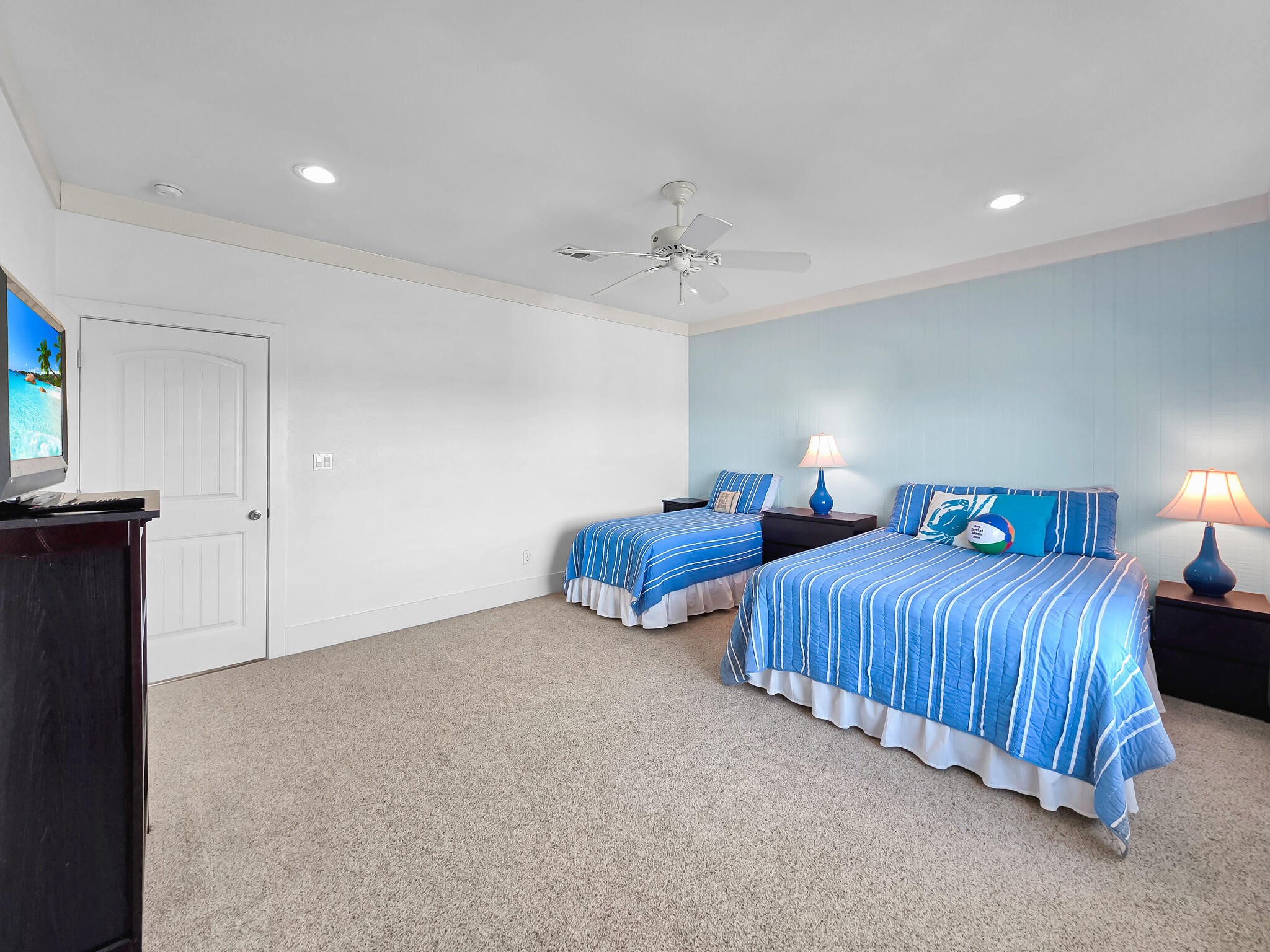 353 Atkinson Street Crystal Beach, TX 77650 - Photo 32 of 42 a bedroom with two beds and a chandelier