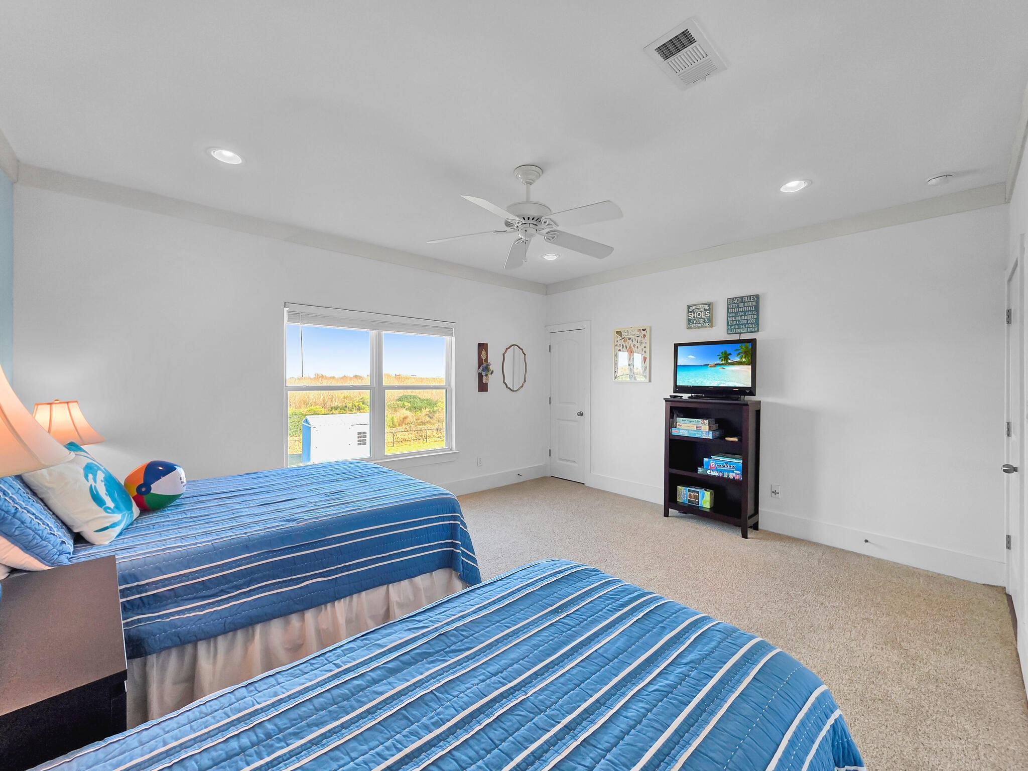 353 Atkinson Street Crystal Beach, TX 77650 - Photo 33 of 42 a bedroom with furniture and a window