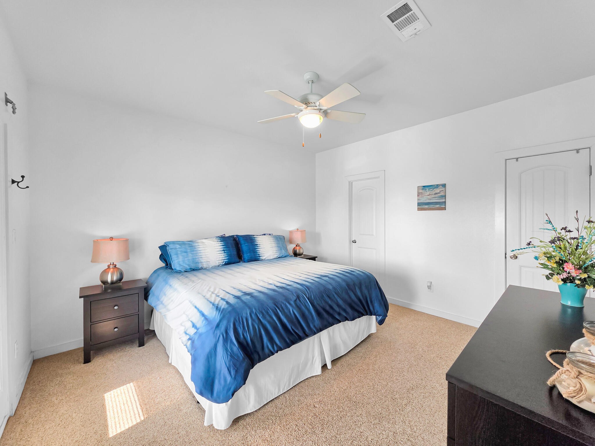 353 Atkinson Street Crystal Beach, TX 77650 - Photo 39 of 42 a bedroom with a bed and a potted plant