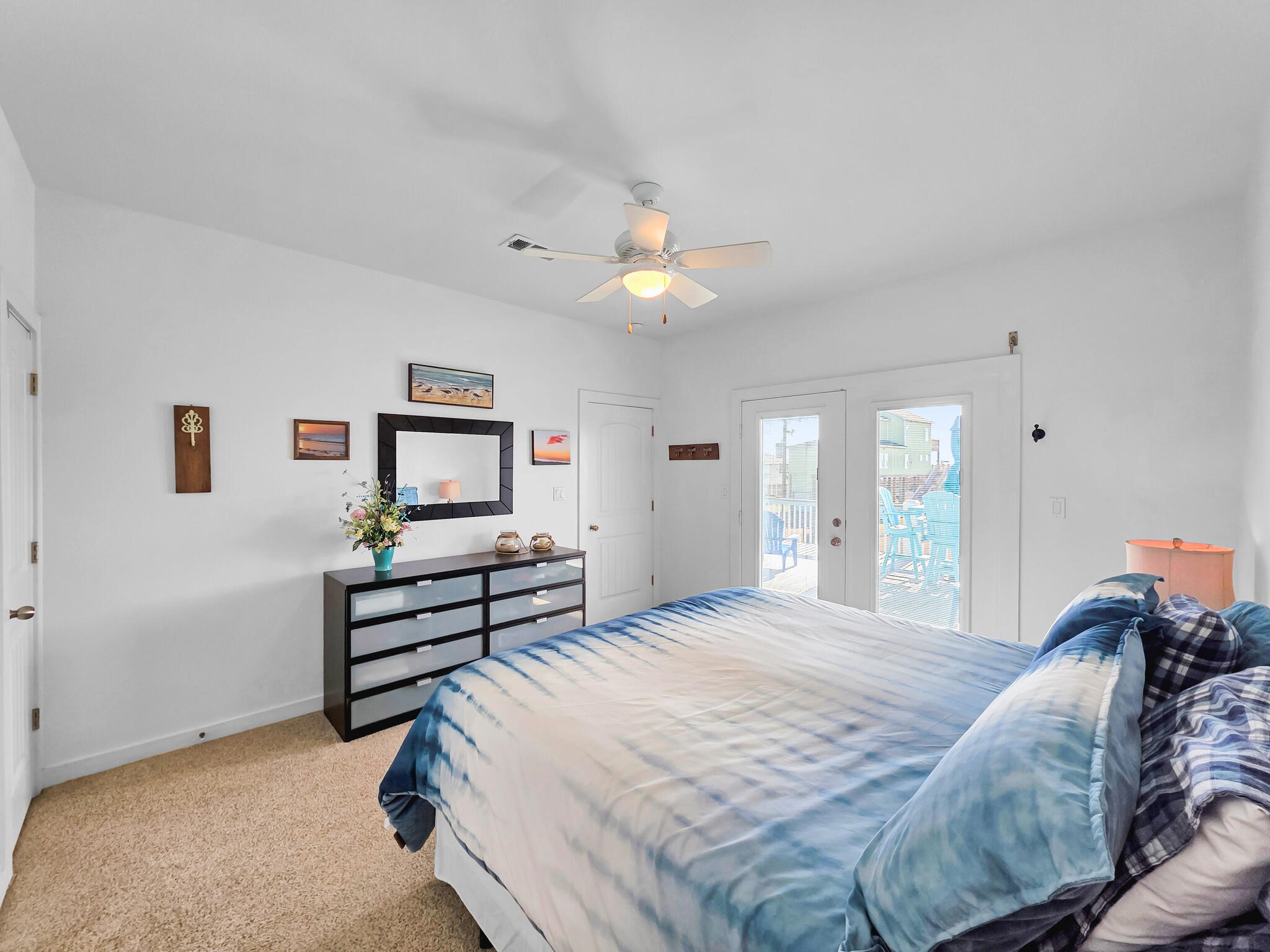 353 Atkinson Street Crystal Beach, TX 77650 - Photo 41 of 42 a bedroom with a bed and a chandelier