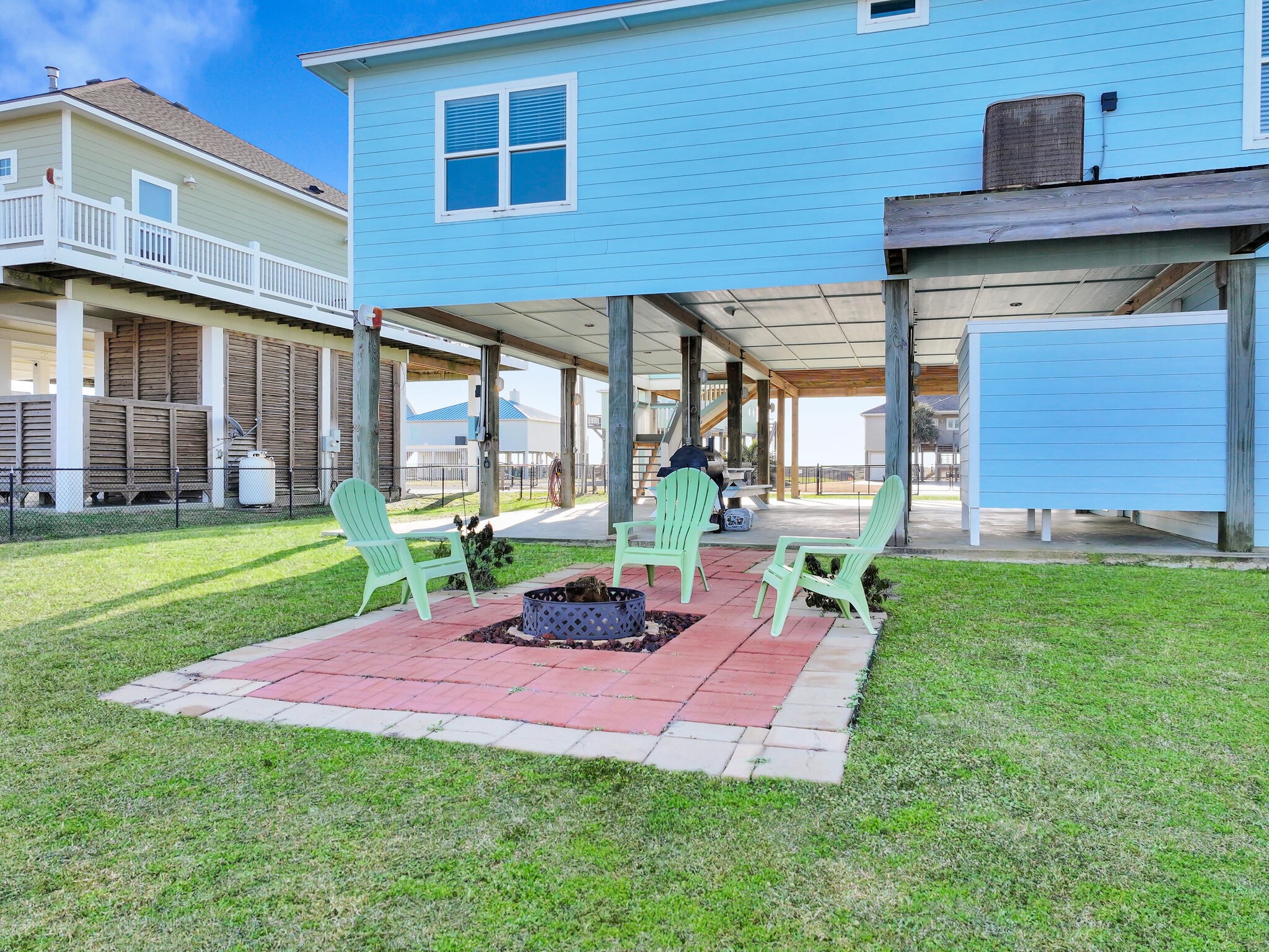 353 Atkinson Street Crystal Beach, TX 77650 - Photo 9 of 42 a view of a backyard with table and chairs and a yard