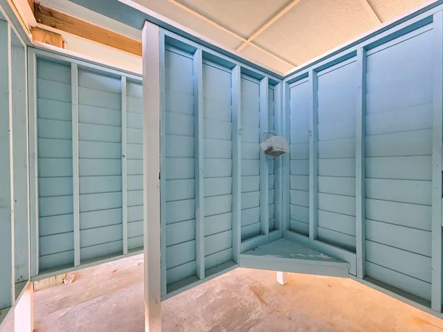 a swimming pool with outdoor seating and a garden