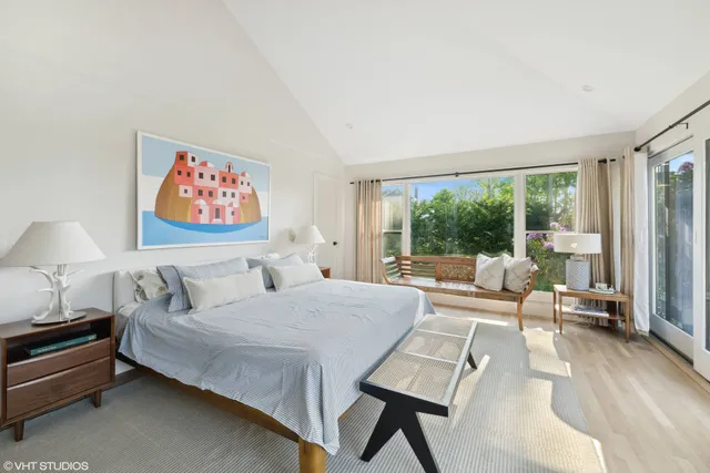 a spacious bedroom with a bed and a large window