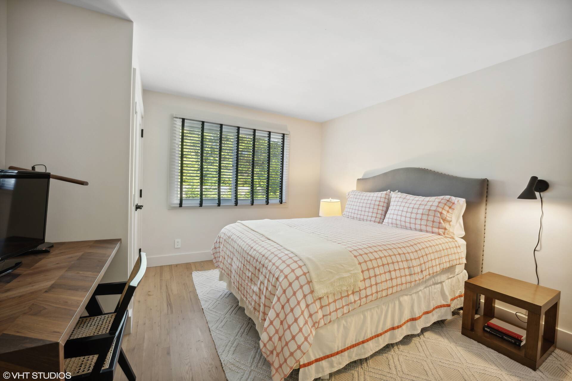 23 Winding Way Water Mill, NY 11976 - Photo 14 of 32 a bedroom with a bed a flat screen tv and a bookshelf