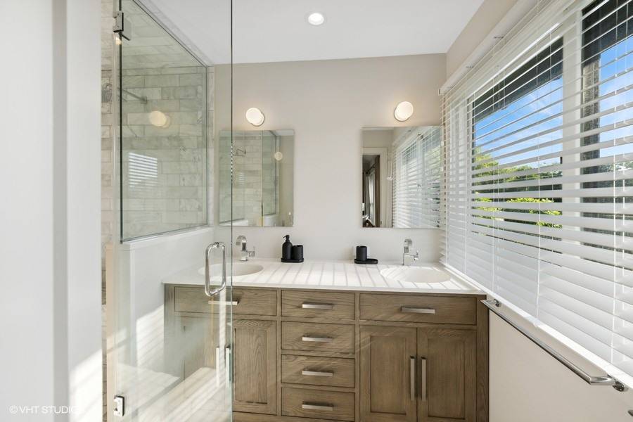 23 Winding Way Water Mill, NY 11976 - Photo 17 of 32 a bathroom with a double vanity sink and a mirror