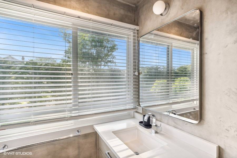 23 Winding Way Water Mill, NY 11976 - Photo 20 of 32 a bathroom with a sink a window and a shower