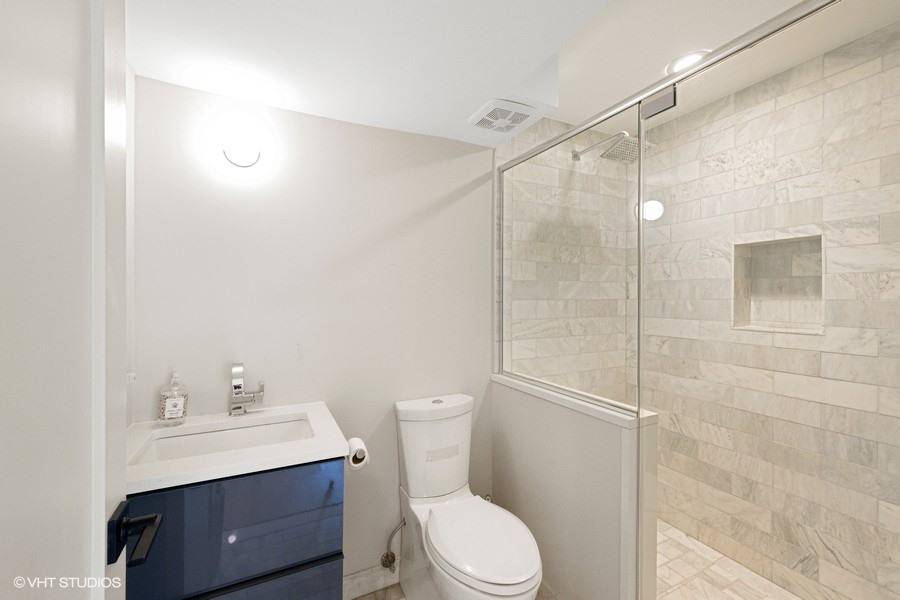 23 Winding Way Water Mill, NY 11976 - Photo 23 of 32 a bathroom with a toilet a sink a mirror and vanity