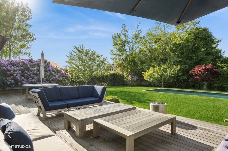 23 Winding Way Water Mill, NY 11976 - Photo 26 of 32 a view of a wooden dinning table and chairs in patio