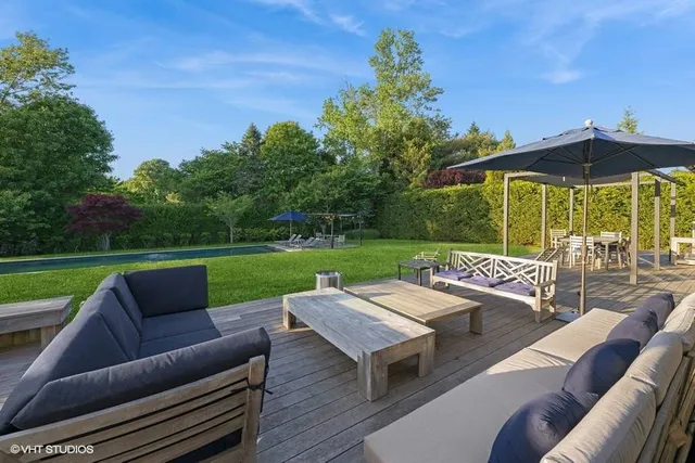 an outdoor sitting area with furniture and garden view