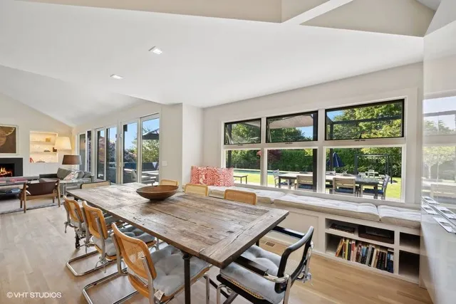 a view of a dining room with furniture large windows and wooden floor