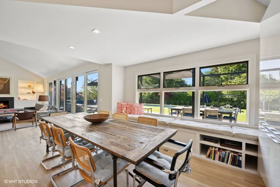 23 Winding Way Water Mill, NY 11976 - Photo 8 of 32 a view of a dining room with furniture large windows and wooden floor