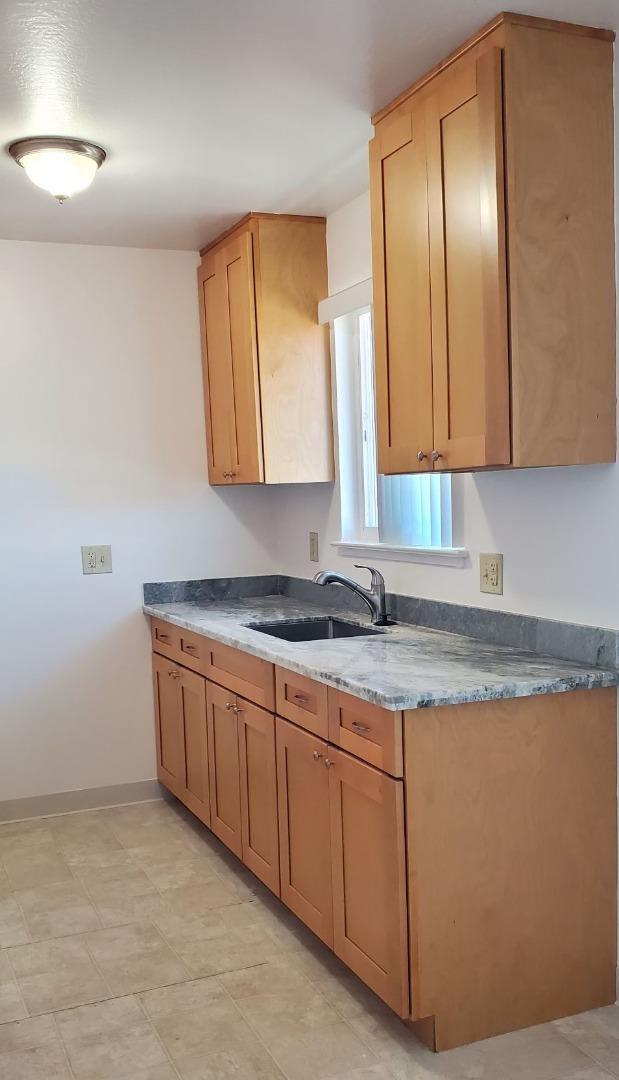 1110 Haddon Drive San Mateo, CA 94402 - Photo 10 of 18 a kitchen with granite countertop a sink and a stove