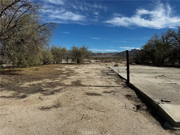 a view of a lake with sunset in background